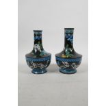 A pair of Chinese black ground cloisonne vases decorated with Asiatic flowers, 6½" high