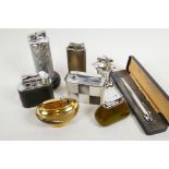 Various table lighters to include a Dunhill standard on base, Polo, a Ronson penciliter in