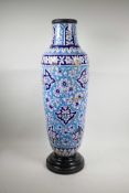 A Persian blue and white pottery vase decorated with a floral pattern, A/F, repairs, 29" high