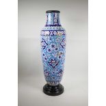 A Persian blue and white pottery vase decorated with a floral pattern, A/F, repairs, 29" high