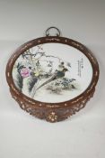 An oval Chinese famille verte porcelain panel decorated with Asiatic birds and flowers, mounted in a