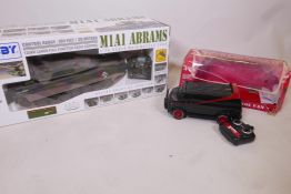 A remote controlled model of an Abram's M1A1 tank, in original box, tank 20" long, and a remote