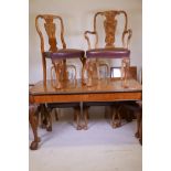 A Queen Anne style faded burr walnut drawleaf dining table, with extra leaf, carved edge top, raised