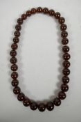 A graduated cherry amber style bead necklace, 22" long