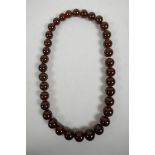 A graduated cherry amber style bead necklace, 22" long