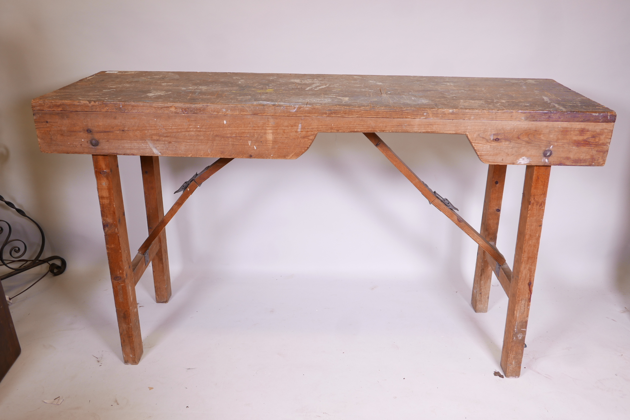 An antique pine workbench, with folding trestle supports, 60" x 20" x 34"