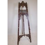 A Kashmiri carved hardwood artist's easel with bobbin turned and symbolic decoration, and inlaid
