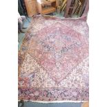 A hand woven deep pile Persian carpet, with central medallion and stylised floral designs in a muted