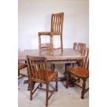 An early C20th oak plank top drawleaf table on a refectory style base, with Tudor style bulbous