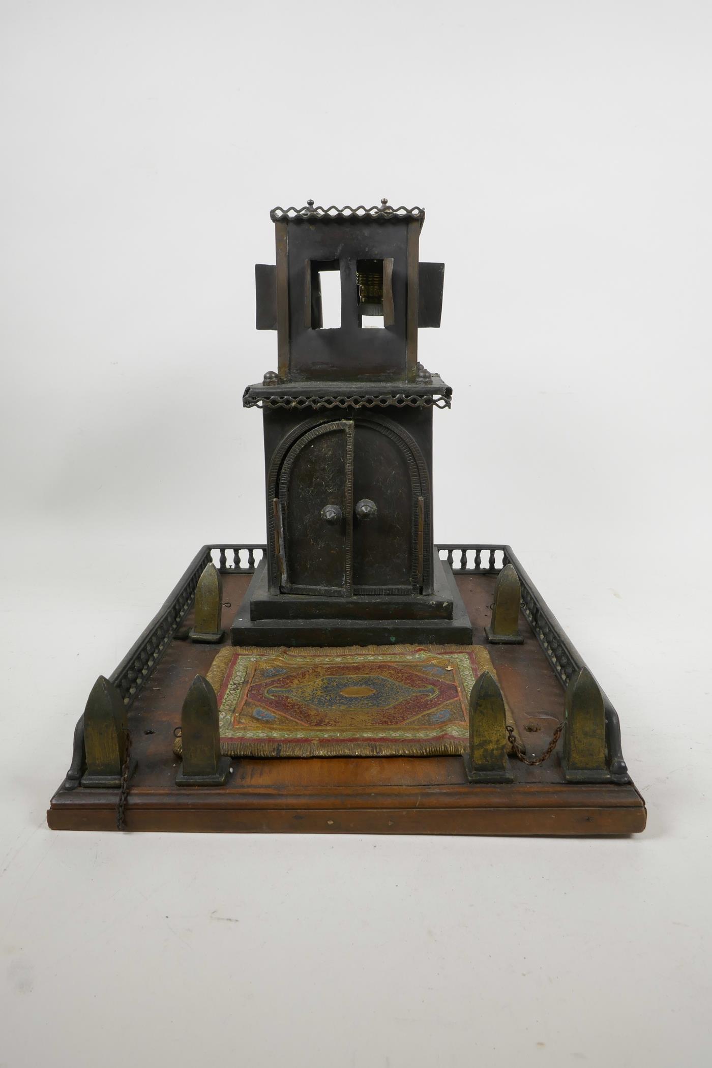 A brass and cold painted bronze lamp in the form of a Middle Eastern dwelling, A/F, 11" high, 10½" x