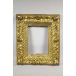 A C17th giltwood picture frame, with carved cherub head and scroll decoration, rebate 10" x 13"