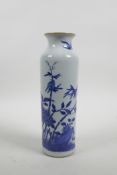 A Chinese blue and white porcelain cylinder vase decorated with birds and butterflies amongst bamboo