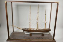A scratch built model of a three masted ship, fitted in a glass case, 30" x 13"