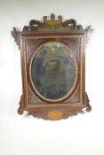 A C19th inlaid mahogany and parcel gilt mirror with carved decoration, 23½" x 33"