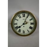 A brass ship's clock, with key, 12" diameter