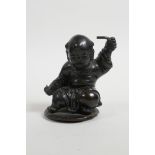 A C19th/20th Chinese bronze mount(?) in the form of a child, 3½" high