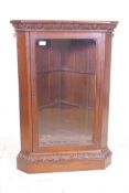 An C18th oak corner cabinet with a glazed door and carved details, 18½" x 18½", 39" high