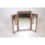 A carved oak triptych dressing table mirror, 28" high, 35" wide (open)