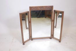A carved oak triptych dressing table mirror, 28" high, 35" wide (open)