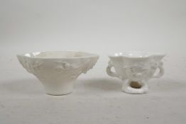 A Chinese blanc de chine porcelain two handled cup, with raised dragon, crane and prunus bossom