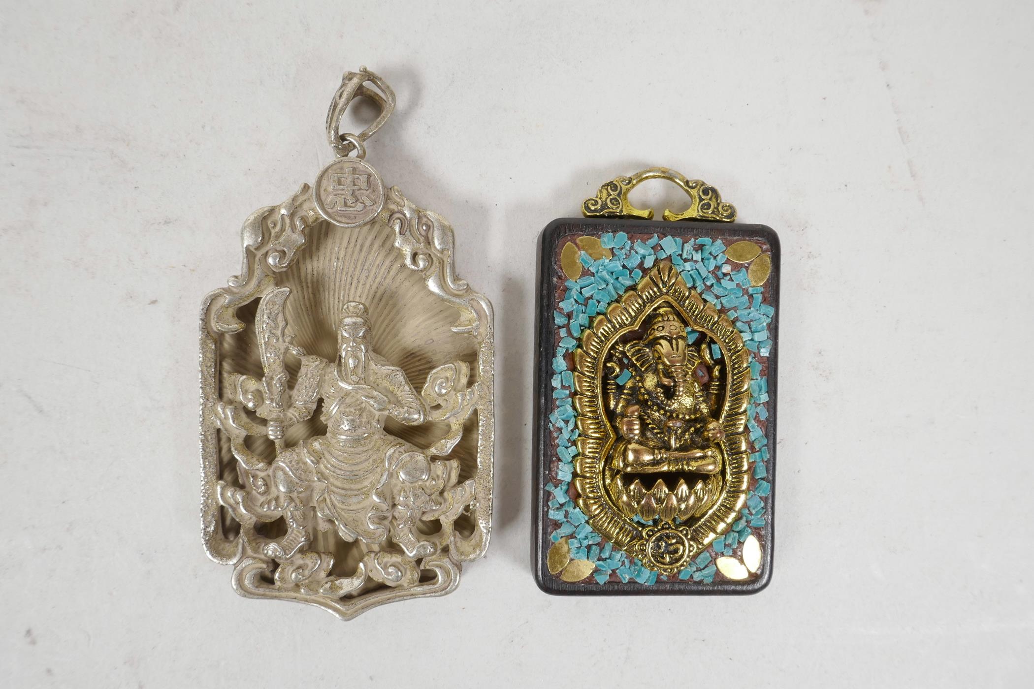 A Chinese white metal pendant decorated with a warrior, together with an Indian pendant decorated