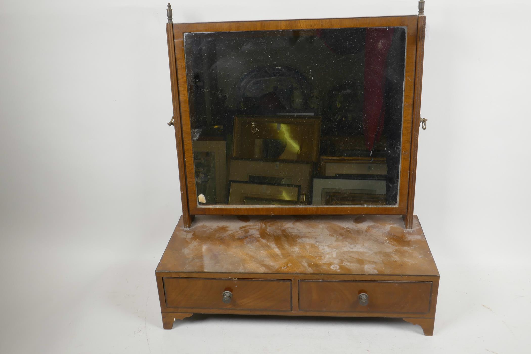 An Edwardian walnut rectangular easel swing toilet mirror on two drawer base with shaped feet, 20"