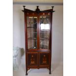 An Art Nouveau style mahogany inlaid corner cabinet, inlaid with copper and pewter, in the manner of