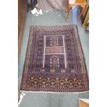 A Persian purple ground silk carpet/hanging, decorated with a geometric design, 57" x 70"