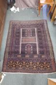 A Persian purple ground silk carpet/hanging, decorated with a geometric design, 57" x 70"