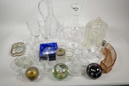 A box of miscellaneous glassware including paper weights, ship's decanter, etched wine glasses, wine