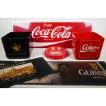 A selection of pub items featuring iconic logos; a perspex Coca-Cola sign, a Coca-Cola ice bucket, a