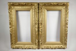 A pair of C19th carved giltwood picture frames, with leaf and scroll decoration, rebates 18½" x 8½"