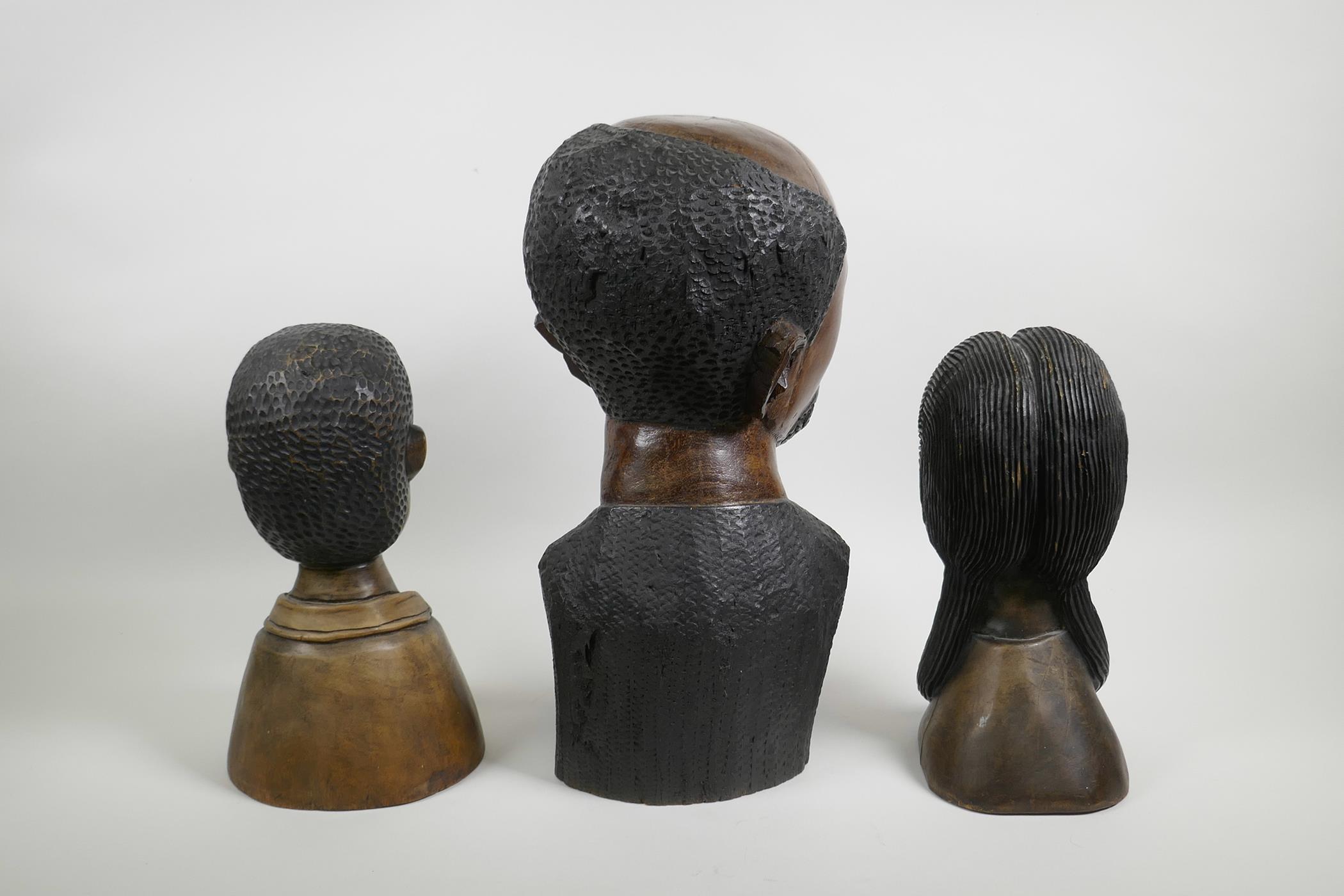 An African carved wood bust of a pipe smoking gentleman together with a pair of carved hardwood - Image 3 of 4