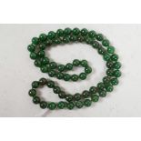 A string of green jade beads, 32" long