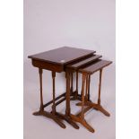 A nest of three mahogany occasional tables, with crossbanded tops, raised on ring turned supports,