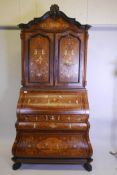 A Continental tulipwood bombe shaped bureau bookcase with ivorine and exotic wood marquetry inlay