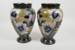 A pair of Doulton Lambeth bulbous vases with raised floral and tube lined decoration marked for