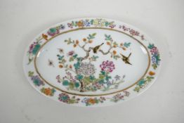 A Chinese polychrome porcelain oval dish with enamel decoration of birds and flowers, 6 character