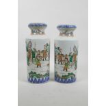 A pair of Chinese famille verte porcelain vases decorated with warriors training in a landscape, 10"