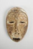 An African carved wood and white clay mask, probably from the Ngbandi, Ngbaka and Ngombe tribal