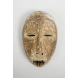 An African carved wood and white clay mask, probably from the Ngbandi, Ngbaka and Ngombe tribal