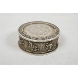 A Chinese white metal coin box and cover, the sides decorated with the emblems of the Eight
