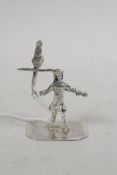 A small silver figurine of a yeoman with bird on a perch, 1¾" high