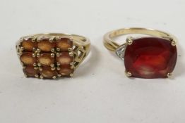 A 9ct gold ring set with nine probable orange topaz oval cut stones in a grid pattern, hallmarked,