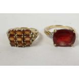 A 9ct gold ring set with nine probable orange topaz oval cut stones in a grid pattern, hallmarked,