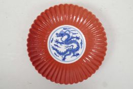 A Chinese blue and white porcelain petal shaped dish with a coral glazed exterior and dragon