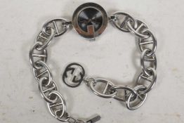 A lady's Gucci stainless steel wristwatch, style 107, number 11027726, on a link bracelet with two
