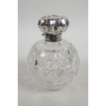 A large Edwardian silver top cut glass perfume bottle, hallmarked Birmingham 1903, inset cut glass