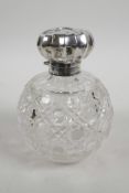A large Edwardian silver top cut glass perfume bottle, hallmarked Birmingham 1903, inset cut glass