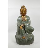 A Chinese green crackle glazed pottery Quan Yin with a gilt face and extremities, 19½" high